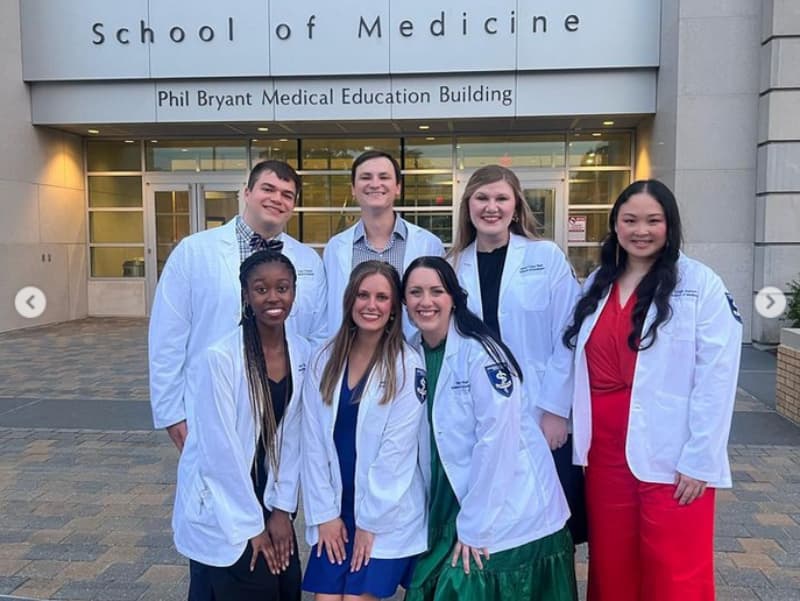 Third year students Libby Li, Brittany Corder, Amye McDonald, and Sabrina Yen pose after receiving their new white coats.